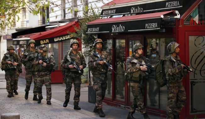 Soldiers operate in St. Denis, a northern suburb of Paris, Wednesday, Nov. 18, 2015. Authorities in the Paris suburb of St. Denis are telling residents to stay inside during a large police operation near France&#x27;s national stadium that two officials say is linked to last week&#x27;s deadly attacks. (AP Photo/Francois Mori)

