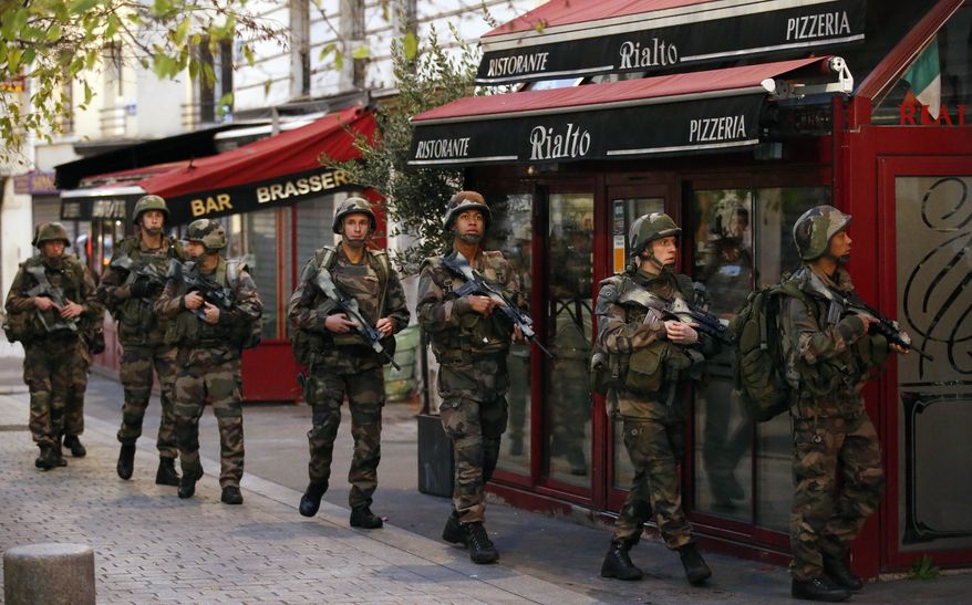 Soldiers operate in St. Denis, a northern suburb of Paris, Wednesday, Nov. 18, 2015. Authorities in the Paris suburb of St. Denis are telling residents to stay inside during a large police operation near France&#x27;s national stadium that two officials say is linked to last week&#x27;s deadly attacks. (AP Photo/Francois Mori)

