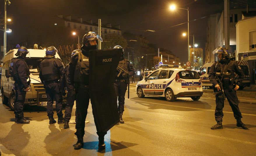 Police forces prepare in Paris on Wednesday after reports of a shooting in the northern suburb of Saint-Denis. (Associated Press)