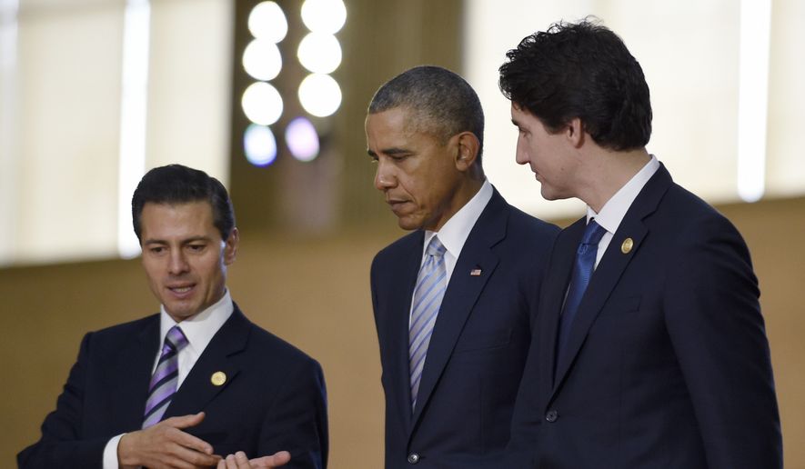 President Barack Obama, center, walks with Mexico&#39;s President Enrique Pena Nieto, left, Canada&#39;s Prime Minister Justin Trudeau, right, as they arrive for a group photo with leaders of the Asia-Pacific Economic Cooperation summit in Manila, Philippines, Thursday, Nov. 19, 2015. (AP Photo/Susan Walsh)