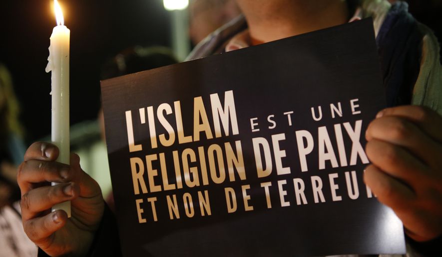 A Moroccan Muslim man holds a banner witch read  &quot;Islam is a religion of peace and not terror &quot; as people gather in solidarity with french people one week after terror attacks in Rabat, Morocco, Friday , Nov. 20, 2015. French President Francois Hollande will preside over a national ceremony on Nov. 27 honoring the victims of the deadliest attacks on France in decades. (AP Photo/Abdeljalil Bounhar)