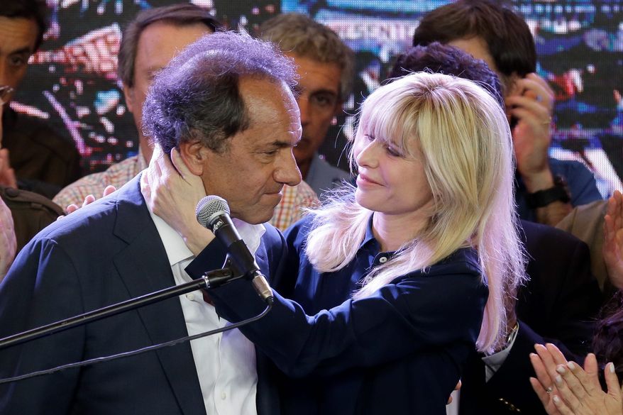 Daniel Scioli, the ruling party presidential candidate, is hugged by wife Karina Rabolini after delivering his concession speech in Buenos Aires on Sunday. (Associated Press)