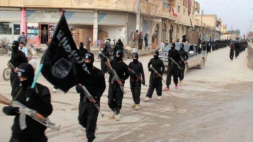 This undated file image posted on a militant website on Jan. 14, 2014, which has been verified and is consistent with other AP reporting, shows fighters from the al Qaeda linked Islamic State of Iraq and the Levant (ISIL) marching in Raqqa, Syria. (AP Photo/Militant Website, File)