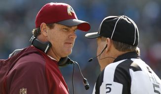 Washington Redskins head coach Jay Gruden, left, talks with head linesman John McGrath, right, in the first half of an NFL football game against the Carolina Panthers in Charlotte, N.C., Sunday, Nov. 22, 2015. (AP Photo/Bob Leverone)