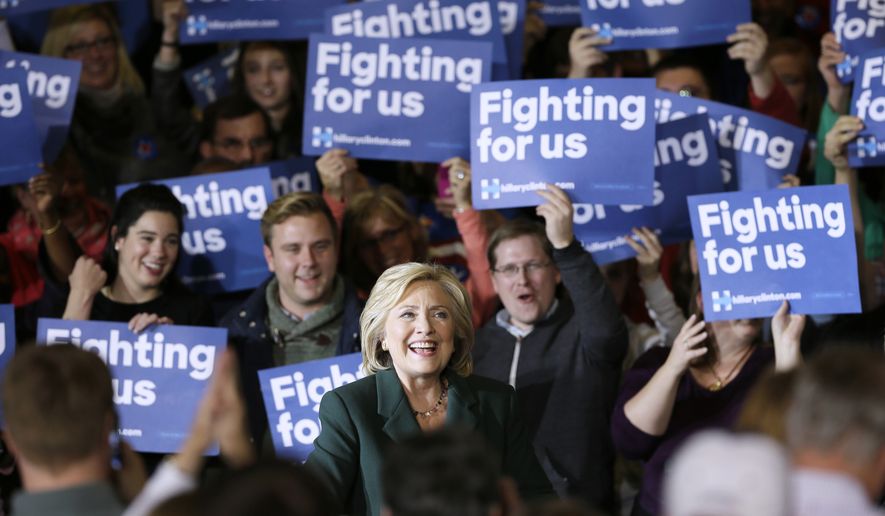 Democratic presidential candidate Hillary Rodham Clinton smiles as she arrives to speak at a town hall meeting Sunday, Nov. 22, 2015, in Clinton, Iowa. (AP Photo/Charlie Neibergall)