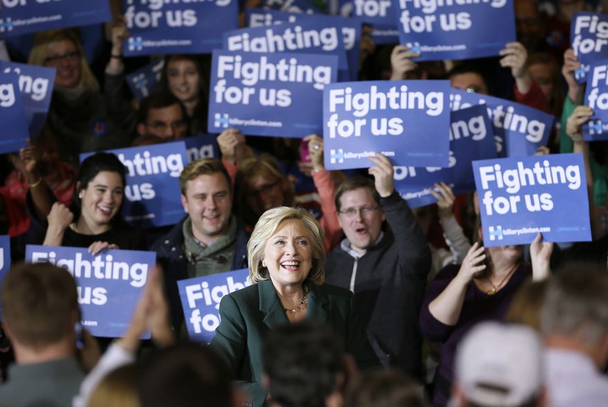 Democratic presidential candidate Hillary Rodham Clinton smiles as she arrives to speak at a town hall meeting Sunday, Nov. 22, 2015, in Clinton, Iowa. (AP Photo/Charlie Neibergall)
