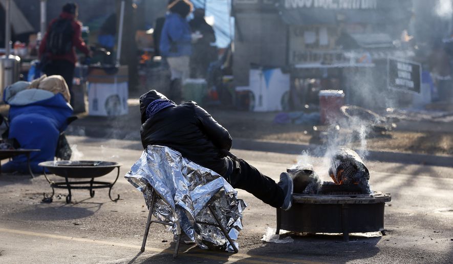 A protester gets some rest at the Black Lives Matter encampment outside the Minneapolis Police Department's Fourth Precinct on Nov. 24. (Associated Press)