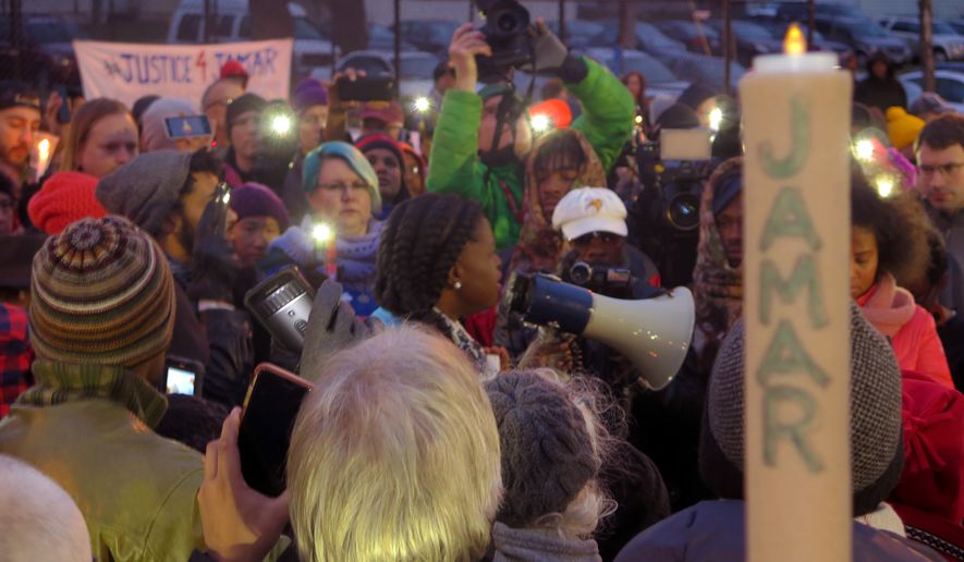 This Nov. 20, 2015, file photo shows Minneapolis NAACP leader Nekima Levy-Pounds speaking at a prayer vigil n Minneapolis. Five people have been shot near the site of an ongoing protest over the fatal shooting of a black man by a police officer, a Minneapolis Police Department spokesman said. (AP Photo/Greg Moore, File)