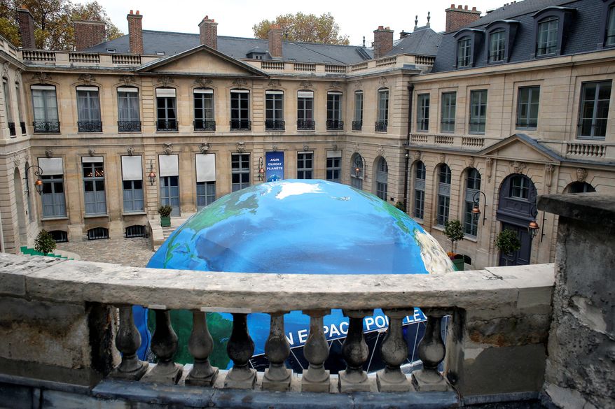 An globelike tent hosting an exhibition on climate is set up in the courtyard of the French Environment Ministry. President Obama will head to a historic climate change summit in Paris next week. (Associated Press)
