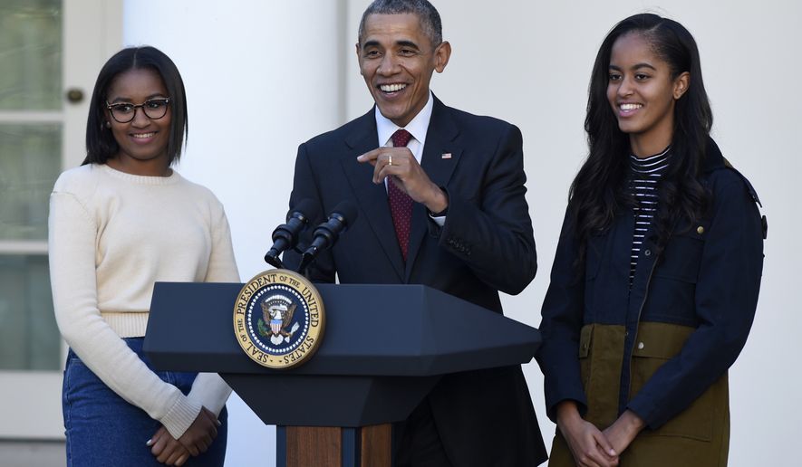 President Barack Obama, with his daughters, Sasha, left, and Malia, speaks before he pardoned the National Thanksgiving Turkey Abe, Wednesday, Nov. 25, 2015, during a ceremony in the Rose Garden of the White House in Washington. This is the 68th anniversary of the National Thanksgiving Turkey presentation (AP Photo/Susan Walsh)