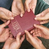 Hands on bible. File photo via Shutterstock.