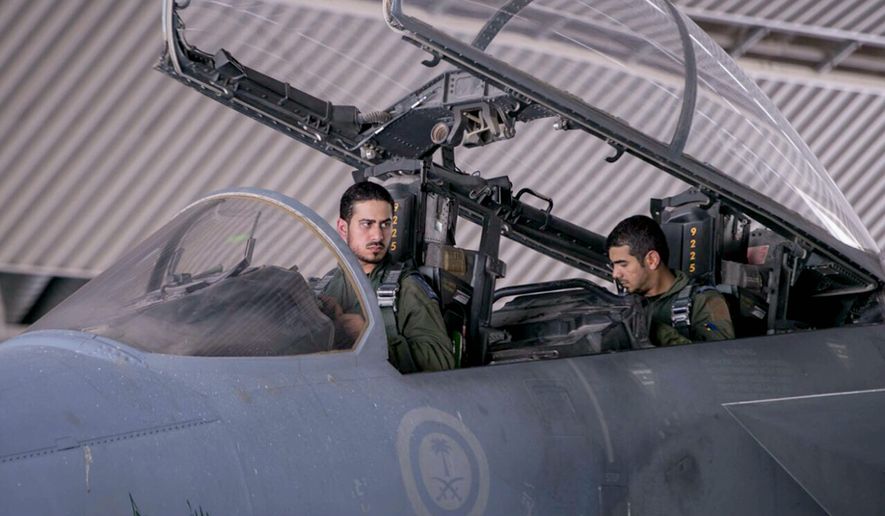 Saudi pilots involved in U.S.-led coalition airstrikes on Islamic State targets sit in the cockpit of a fighter jet in Saudi Arabia on Sept. 24. (Associated Press)