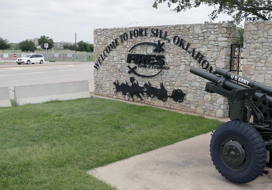FILE - In this June 17, 2014 file photo, a vehicle drives by a sign at Scott Gate, one of the entrances to Fort Sill, in Fort Sill, Okla. The Army said that Oklahoma’s Fort Sill will see a 3 percent increase in soldiers in the next two years, but overall troop strength at the Army base will remain 30 percent below 2001 numbers. (AP Photo/Sue Ogrocki, File)