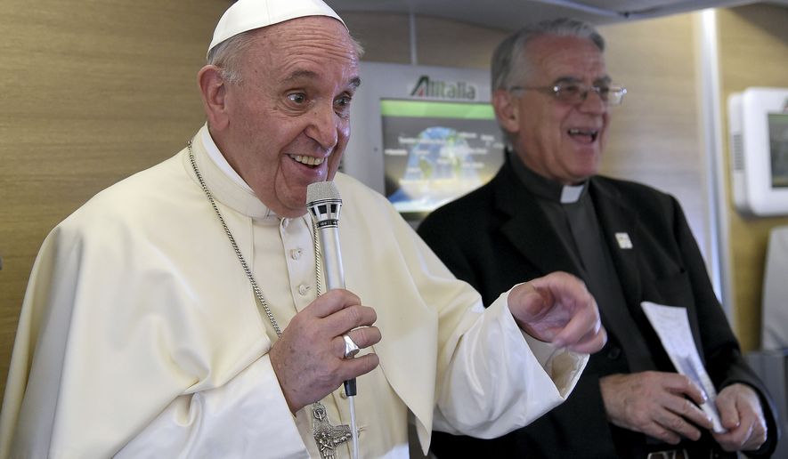 Pope Francis talks to journalists during a press conference he held aboard the flight on the way back to the Vatican, Monday, Nov. 30, 2015. Pope Francis traveled to Africa for a six-day visit that took him to Kenya, Uganda and the Central African Republic. (Daniel Dal Zennaro/Pool Photo via AP)
