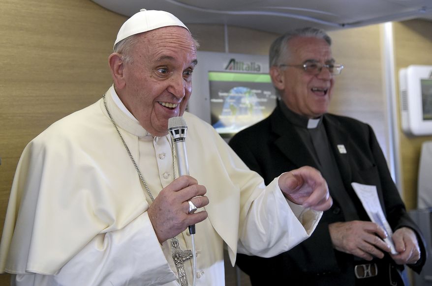 Pope Francis talks to journalists during a press conference he held aboard the flight on the way back to the Vatican, Monday, Nov. 30, 2015. Pope Francis traveled to Africa for a six-day visit that took him to Kenya, Uganda and the Central African Republic. (Daniel Dal Zennaro/Pool Photo via AP)