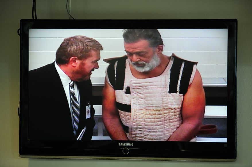Colorado Springs shooting suspect Robert Lewis Dear Jr. (right) — with public defender Dan King — appears via video before Judge Gilbert Martinez for his first court appearance. (Associated Press)