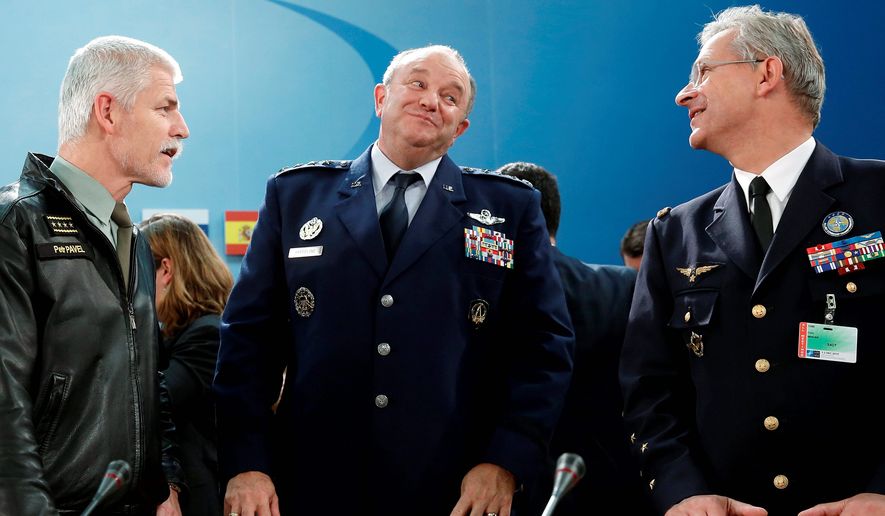 NATO Supreme Allied Commander General Philip Breedlove (center) speaks with Czech Army General Petr Pavel (left) and French Air Force General Denis Mercier as the mutual-defense organization considers admitting Montenegro, a move Moscow says reverts to a Cold War policy of &quot;containing&quot; Russia. (Associated Press)
