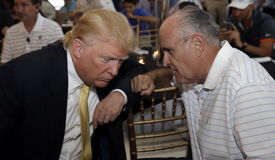 Republican presidential candidate Donald Trump (left) talks with former New York City Mayor Rudy Giuliani at a fundraising event in the Bronx borough of New York on July 6, 2015. (Associated Press) **FILE**