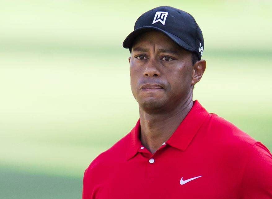 Tiger Woods watches a chip shot to the 15th green during the final round of the Wyndham Championship golf tournament at Sedgefield Country Club in Greensboro, N.C., Sunday, Aug. 23, 2015. (AP Photo/Rob Brown)