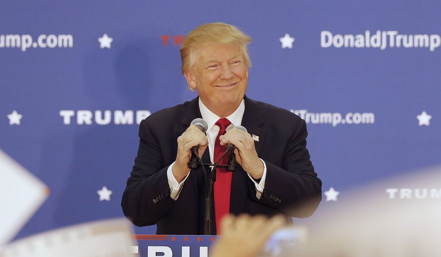 Republican presidential candidate Donald Trump smiles as he arrives at a campaign stop at the White Mountain Athletic Club  Tuesday, Dec. 1, 2015, in Waterville Valley, N.H. (AP Photo/Jim Cole)