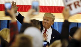 Republican presidential candidate Donald Trump waves as he arrives at a campaign stop at the White Mountain Athletic Club Tuesday, Dec. 1, 2015, in Waterville Valley, N.H. (AP Photo/Jim Cole)