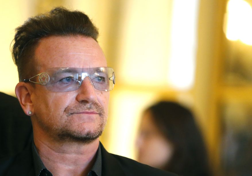 This July 16, 2013, file photo shows Bono during the ceremony where he was inducted as an "Officier dans l'Ordre des Arts et Lettres" (Officer in the Order of Arts and Letters) at the Culture Ministry in Paris. (AP Photo/Jacques Brinon, File)