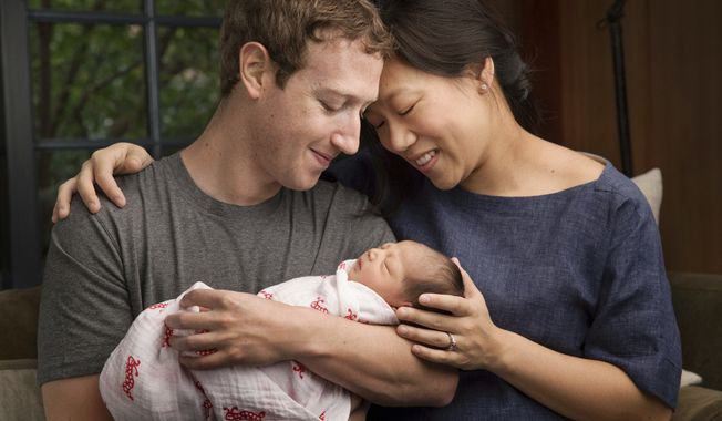 In this undated photo provided by Mark Zuckerberg, Max Chan Zuckerberg is held by her parents, Mark Zuckerberg and Priscilla Chan Zuckerberg. Facebook CEO Mark Zuckerberg and his wife announced the birth of their daughter, Max, as well as plans to donate most of their wealth to a new organization that will tackle a broad range of the world&#x27;s ills. (Mark Zuckerberg via AP)
