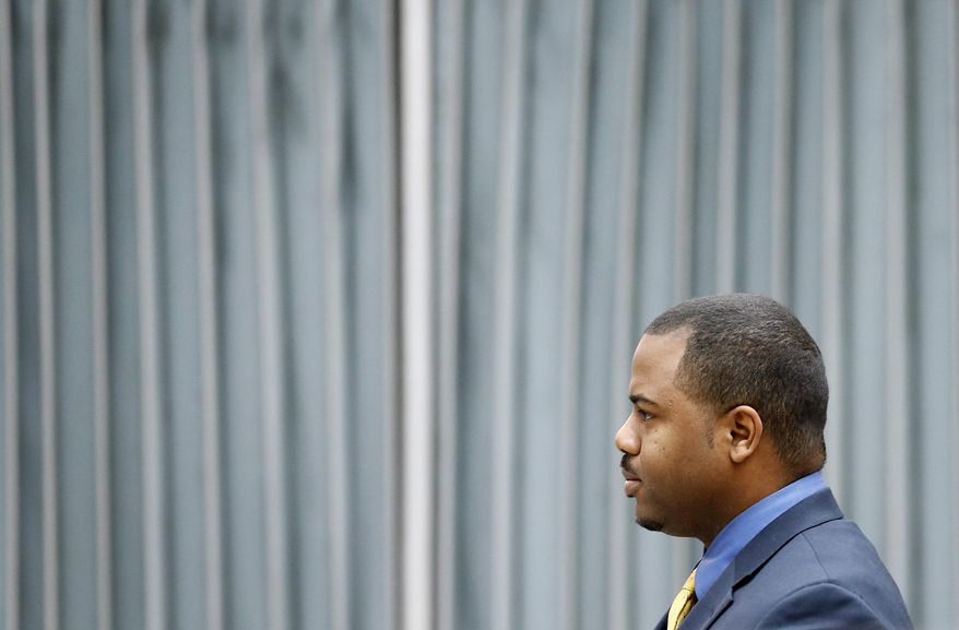 William Porter, one of six Baltimore city police officers charged in connection to the death of Freddie Gray, walks to a courthouse for jury selection in his trial, Monday, Nov. 30, 2015, in Baltimore. Porter faces charges of manslaughter, assault, reckless endangerment and misconduct in office. (AP Photo/Patrick Semansky, Pool)