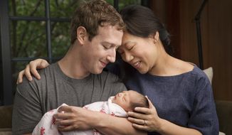 In this undated photo provided by Mark Zuckerberg, Max Chan Zuckerberg is held by her parents, Mark Zuckerberg and Priscilla Chan Zuckerberg. Facebook CEO Mark Zuckerberg and his wife announced the birth of their daughter, Max, as well as plans to donate most of their wealth to a new organization that will tackle a broad range of the world&#39;s ills. (Mark Zuckerberg via AP)