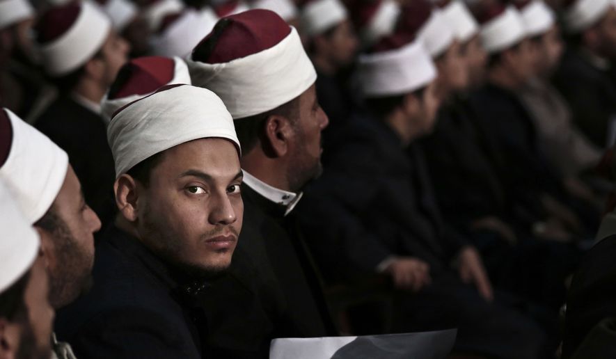 Egyptian Al-Azhar students wait for Sheikh Ahmed el-Tayeb, Grand Imam of Al-Azhar, the pre-eminent institute of Islamic learning in the Sunni Muslim world, to deliver a speech to university students and clerics, at Cairo University, Egypt, Tuesday, Dec. 1, 2015. (AP Photo/Nariman El-Mofty)