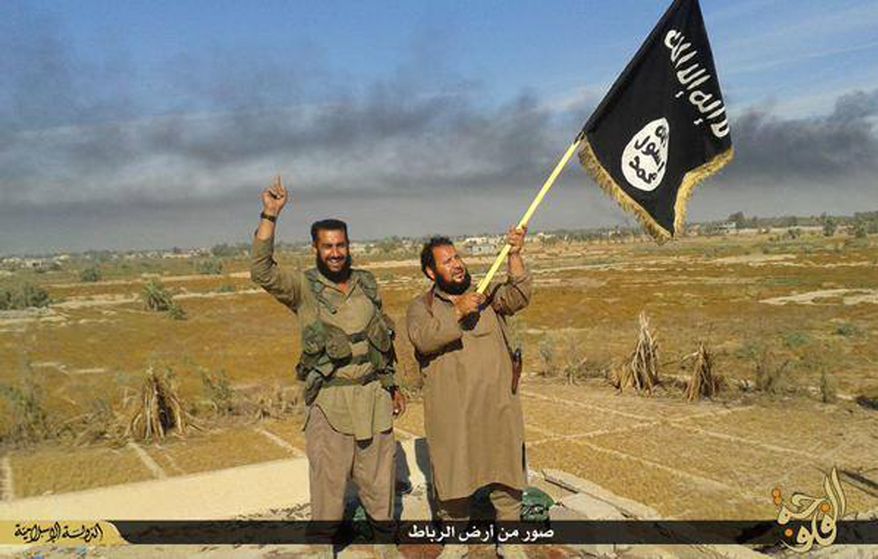 FILE - In this file photo released on Sunday, June 28, 2015, by a website of Islamic State militants, an Islamic State militant waves his group&#39;s flag as he and another celebrate in Fallujah, Iraq, west of Baghdad.The Islamic State&amp;#8217;s gruesome rampage across the Middle East has united the world in horror but left it divided over how to refer to the group, with observers adopting different acronyms based on their translation of an archaic geographical term and the extent to which they want to needle the group. (Militant website via AP, File)