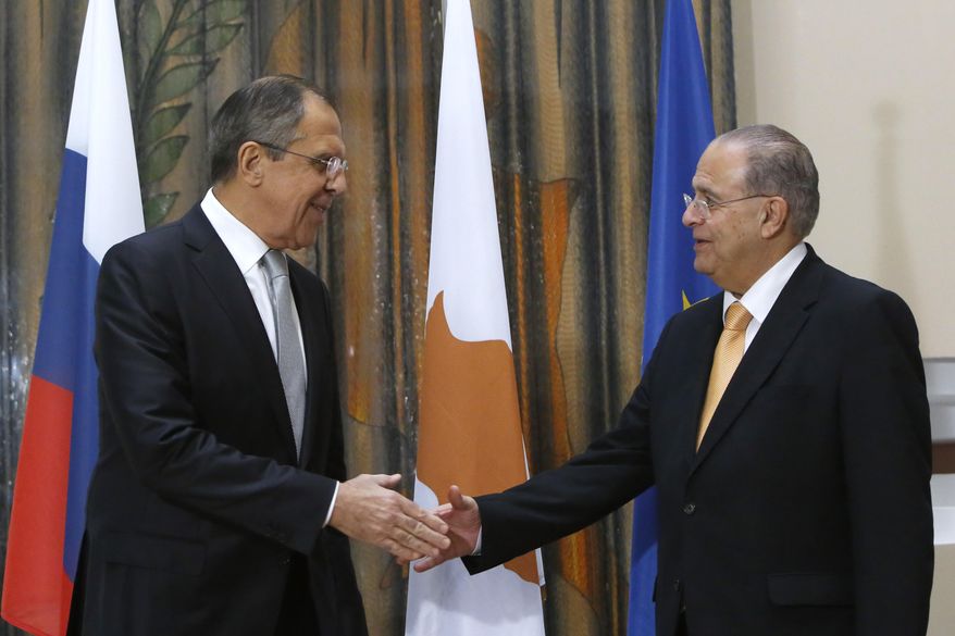 Russian Foreign Minister Sergey Lavrov, left, and Cypriot Foreign Minister Ioannis Kasoulides, shake hands before their talks at the foreign ministry house in Nicosia, on Wednesday, Dec. 2, 2015. Foreign Minister Lavrov is Cyprus for 24 hours official visit. (AP Photo/Petros Karadjias)
