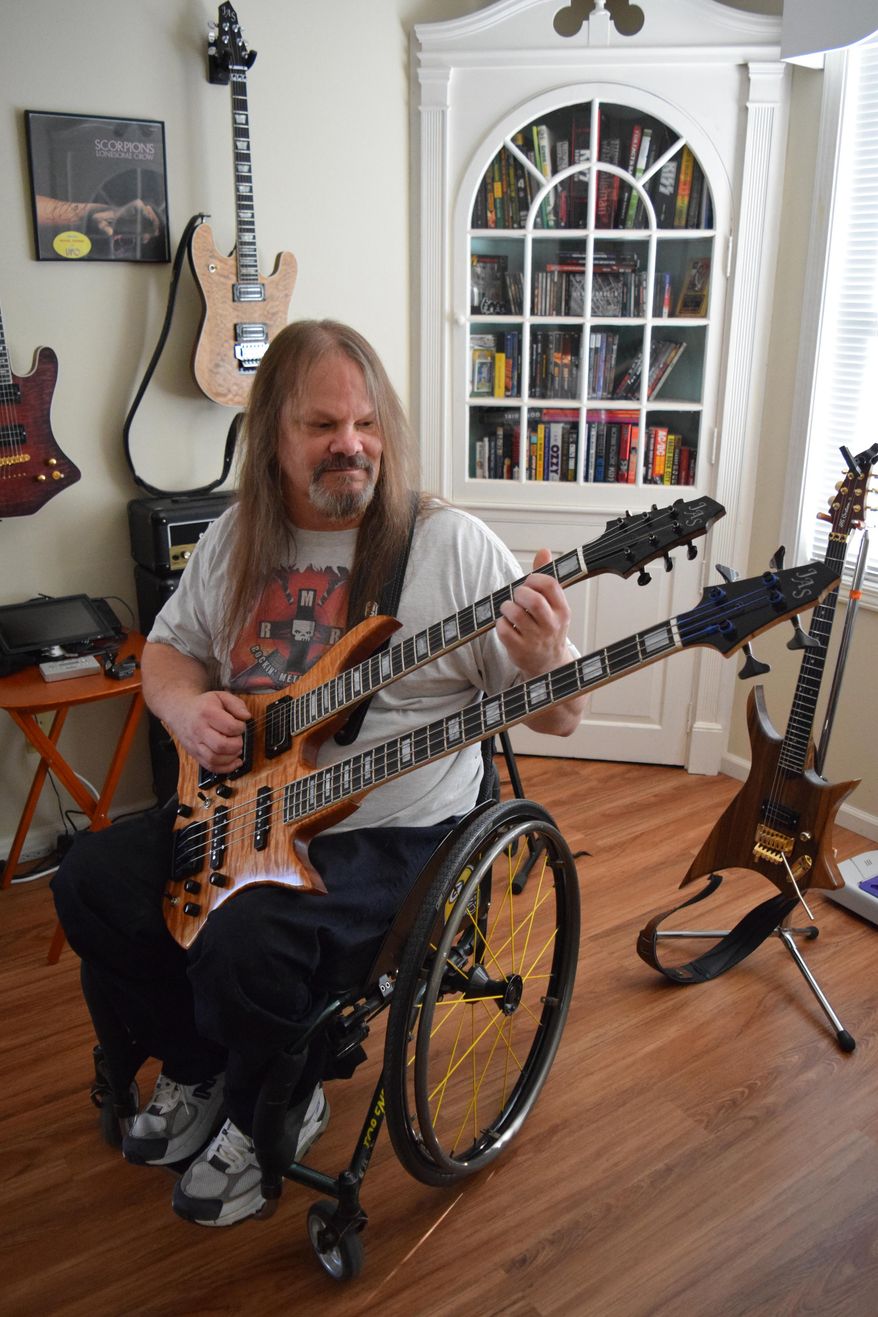 ADVANCE FOR WEEKEND EDITIONS, DEC. 5-6 - In this photo taken Nov. 11, 2015, Jerry Swanson plays his double-necked combination six-string/bass guitar in Beloit, Wis. Swanson makes custom guitars in the workshop behind his home. (Erica Pennington/The Beloit Daily News via AP) MANDATORY CREDIT