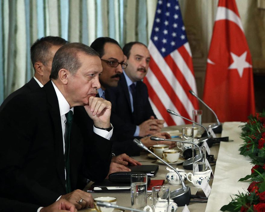 Turkish President Recep Tayyip Erdogan, left, listens to President Barack Obama during a bilateral meeting in Paris, France, Tuesday, Dec. 1, 2015. The leaders discussed the continuing crisis in Syria, and the fight against the Islamic State group. (AP Photo/Yasin Bulbul, Presidential Press Service, Pool)