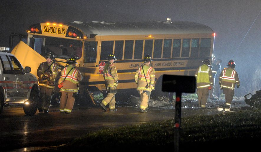 Authorities investigate the scene of an accident involving a school bus and a vehicle on Tuesday, Dec. 1, 2015, in Southampton, N.J. State Police said the school bus and a vehicle collided, leaving at least one person in the car seriously injured. (Tom Gralish/The Philadelphia Inquirer via AP) PHIX OUT; TV OUT; MAGS OUT; NEWARK OUT; MANDATORY CREDIT
