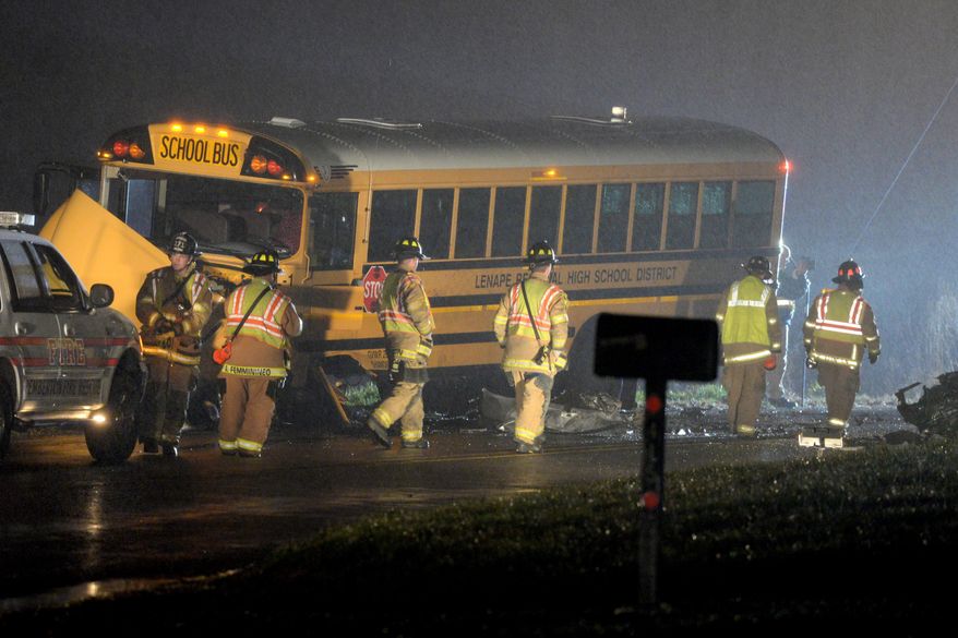 Authorities investigate the scene of an accident involving a school bus and a vehicle on Tuesday, Dec. 1, 2015, in Southampton, N.J. State Police said the school bus and a vehicle collided, leaving at least one person in the car seriously injured. (Tom Gralish/The Philadelphia Inquirer via AP) PHIX OUT; TV OUT; MAGS OUT; NEWARK OUT; MANDATORY CREDIT