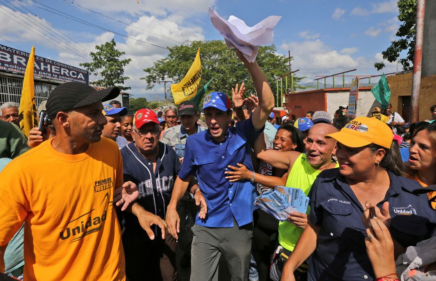 Opposition leader and Miranda state Gov. Henrique Capriles rallies supporters ahead of the Dec. 6 Venezuelan congressional elections that represent the stiffest challenge in 16 years for the ruling socialist party. (Associated Press photographs)