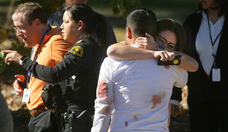 A couple embraces following a shooting that killed multiple people at a social services facility, Wednesday, Dec. 2, 2015, in San Bernardino, Calif. (David Bauman/The Press-Enterprise via AP)
