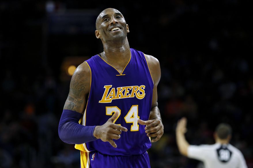 Los Angeles Lakers' Kobe Bryant smiles as he jogs to the bench during the first half of an NBA basketball game against the Philadelphia 76ers, Tuesday, Dec. 1, 2015, in Philadelphia. (AP Photo/Matt Slocum)