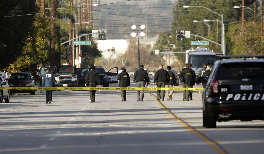 Investigators search for bullet casings at the scene where Wednesday&#39;s police shootout with suspects took place, Thursday, Dec. 3, 2015, in San Bernardino, Calif. A heavily armed man and woman dressed for battle opened fire on a holiday banquet for his co-workers Wednesday, killing multiple people and seriously wounding others in a precision assault, authorities said. Hours later, they died in a shootout with police.(AP Photo/Jae C. Hong)
