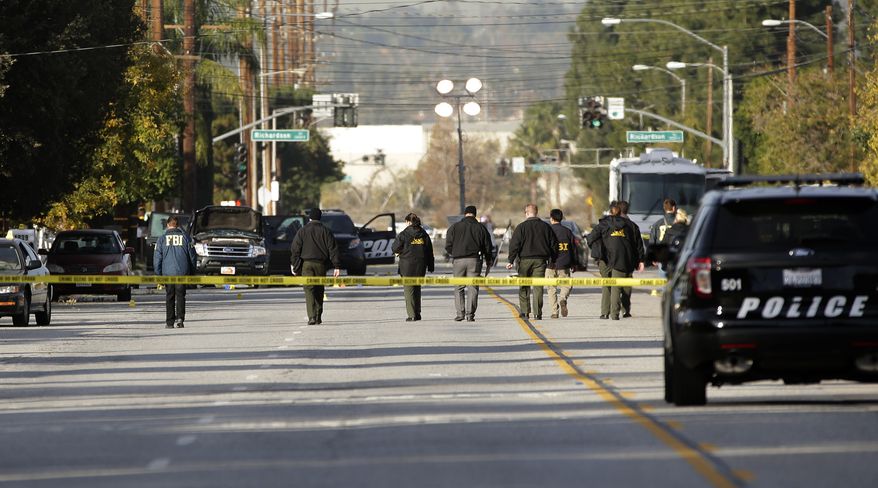 Investigators search for bullet casings at the scene where Wednesday's police shootout with suspects took place, Thursday, Dec. 3, 2015, in San Bernardino, Calif. A heavily armed man and woman dressed for battle opened fire on a holiday banquet for his co-workers Wednesday, killing multiple people and seriously wounding others in a precision assault, authorities said. Hours later, they died in a shootout with police.(AP Photo/Jae C. Hong)