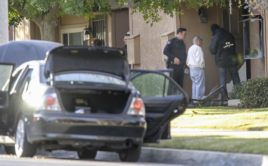 FBI agents interview a man, center, outside a home in connection to the shootings in San Bernardino, Thursday, Dec. 3, 2015, in Redlands, Calif. A heavily armed man and woman opened fire Wednesday on a holiday banquet for his co-workers, killing multiple people and seriously wounding others in a precision assault, authorities said. Hours later, they died in a shootout with police. (AP Photo/Ringo H.W. Chiu) ** FILE **