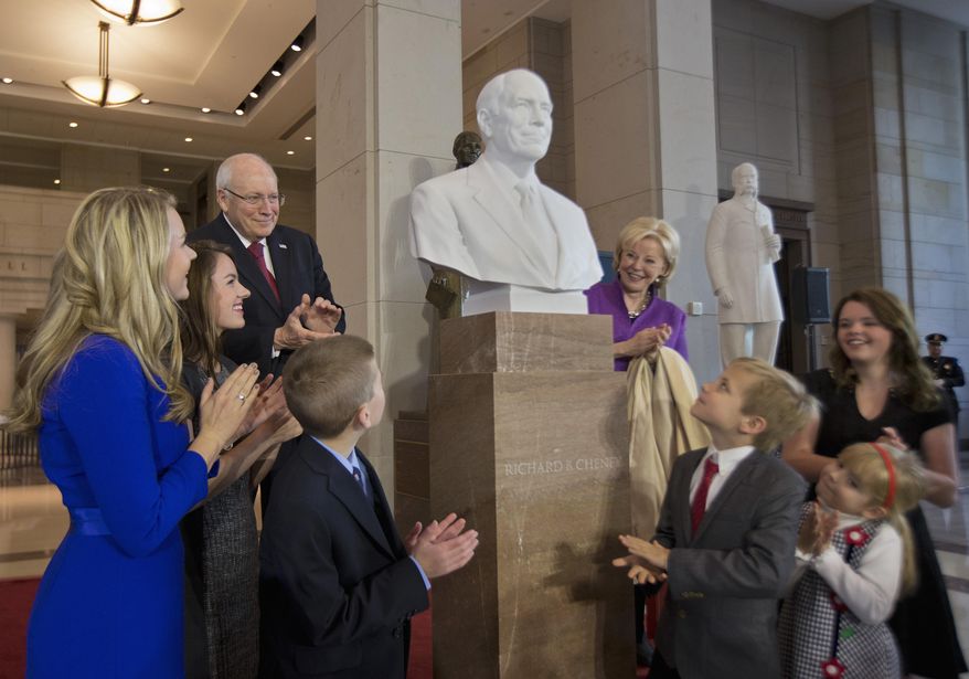 Former Vice President Dick Cheney, back left, his wife Lynne Cheney, back right, and their grandchildren applaud as his marble bust is unveiled in the Emancipation Hall on Capitol Hill in Washington, Thursday, Dec. 3, 2015. Congressional leaders and former President George W. Bush paid tribute to Cheney, who also served as congressman from Wyoming. (AP Photo/Manuel Balce Ceneta)