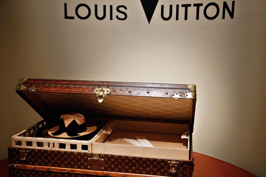 A 1906 trunk owned by Louis Vuitton is displayed at the Louis Vuitton's exhibition "Fly, Sail, Travel" at the Grand Palais, in Paris, Thursday, Dec. 3, 2015. Fashion powerhouse Louis Vuitton is showcasing its 160-years of know-how in Paris with a new exhibit that probes deep inside the history of the famed monogram bags. (AP Photo/Thibault Camus)