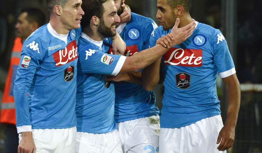 Napoli&#39;s Gonzalo Higuain, second from left, celebrates with his teammates after scoring his second goal during a Serie A soccer match between Napoli and Inter Milan, at the San Paolo stadium in Naples, Italy, Monday, Nov. 30, 2015. (AP Photo/Salvatore Laporta)