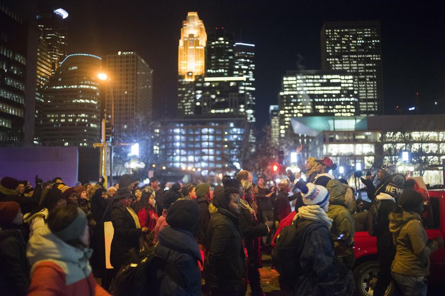 Black Lives Matter protesters marched from City Hall to Elsie and finally to the Police Officers Federation in northeast Minneapolis to demand answers in the death of Jamar Clark . (Richard Tsong-Taatarii/Star Tribune via AP)