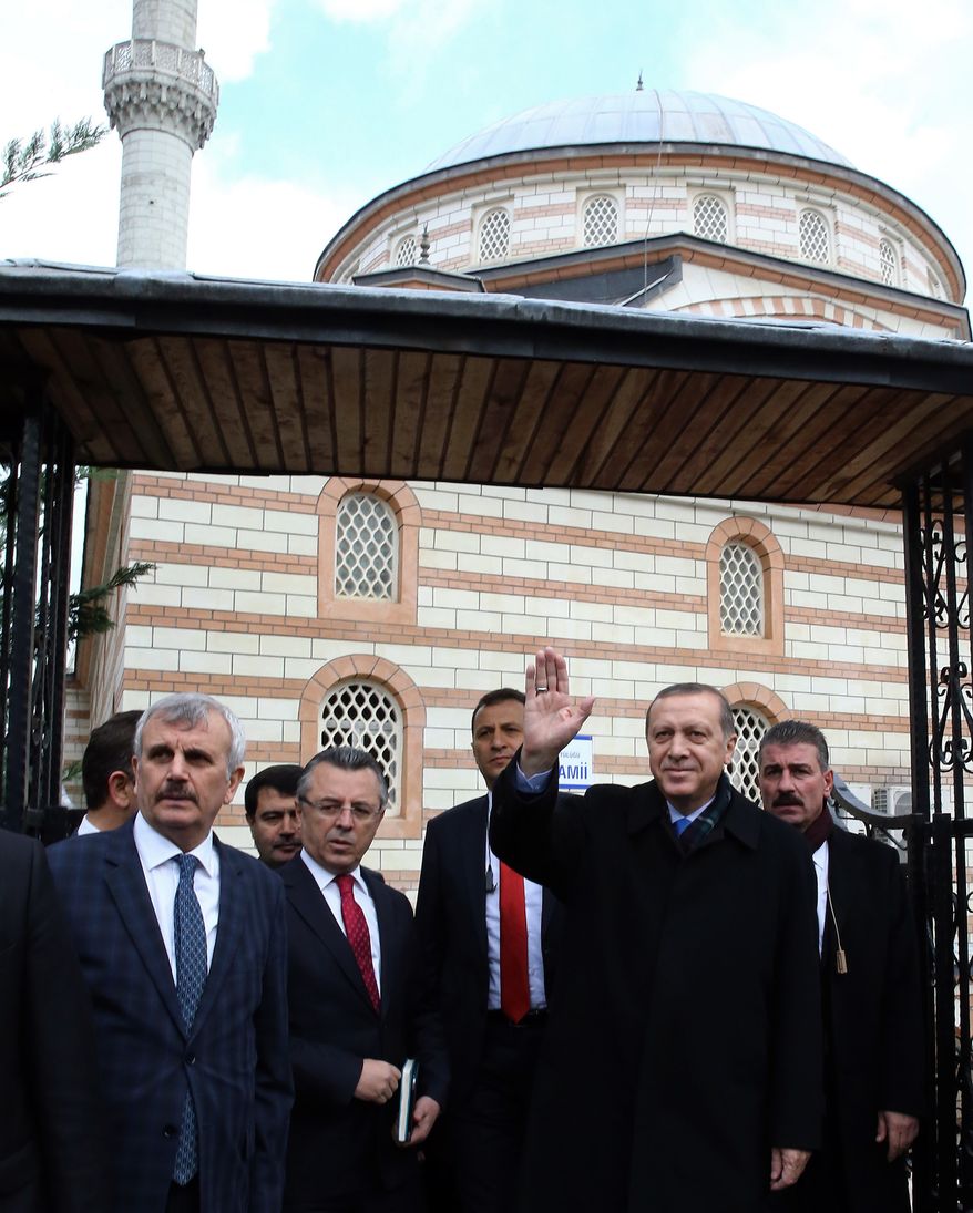 Turkey's President Recep Tayyip Erdogan waves to supporters after Friday prayers in Istanbul, Turkey, Friday, Dec. 4, 2015. Russia's President Vladimir Putin on Thursday hinted at more sanctions against Turkey and accused Turkey of a "treacherous war crime" in downing a Russian jet at the border with Syria. “Allah must have punished Turkey’s ruling clique by depriving it of sense and reason,” Putin said. Erdogan has hotly denied that his country was involved in oil trade with the IS, and has pledged to step down if Moscow proves its accusations.(AP Photo/Murat Cetinmuhurdar, Presidential Press Service, Pool)