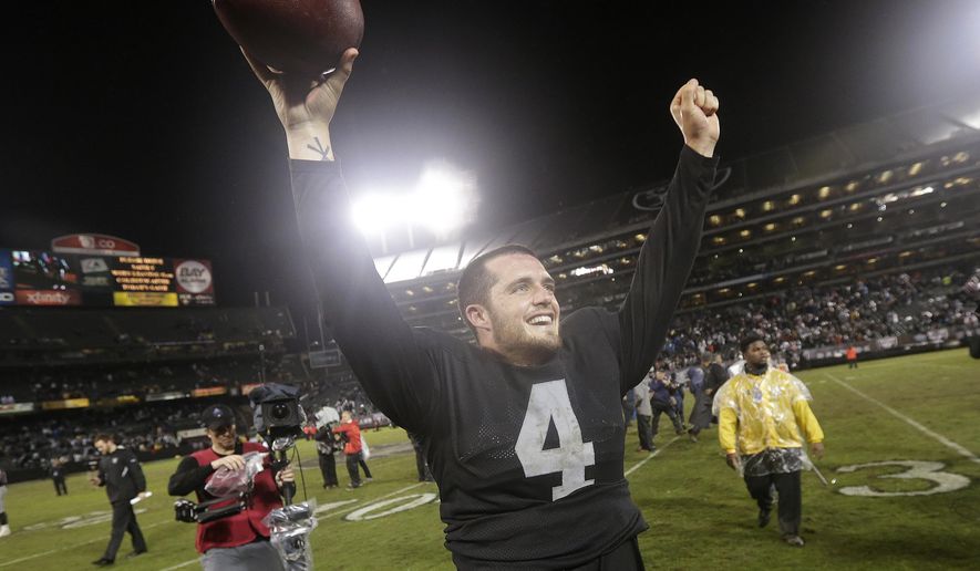 FILE  - In this Nov. 20, 2014, file photo, Oakland Raiders quarterback Derek Carr (4) celebrates after the Raiders defeated the Kansas City Chiefs 24-20 in an NFL football game in Oakland, Calif. That was a sign of things to come for Carr, whose dramatic improvement in year two is the biggest reason why the Raiders (5-6) are still in the playoff hunt in December heading into Sunday&#39;s home game against the streaking Chiefs (6-5). (AP Photo/Marcio Jose Sanchez, File)