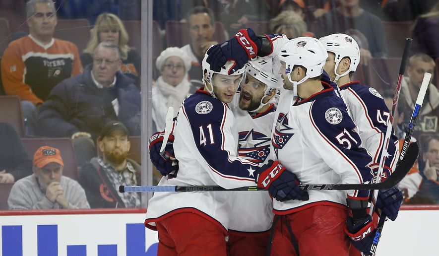 Columbus Blue Jackets&#39; Alexander Wennberg (41), Nick Foligno (71), Fedor Tyutin (51) and Dalton Prout (47) celebrate after a goal by Folingo during the first period of an NHL hockey game against the Philadelphia Flyers, Saturday, Dec. 5, 2015, in Philadelphia. (AP Photo/Matt Slocum)