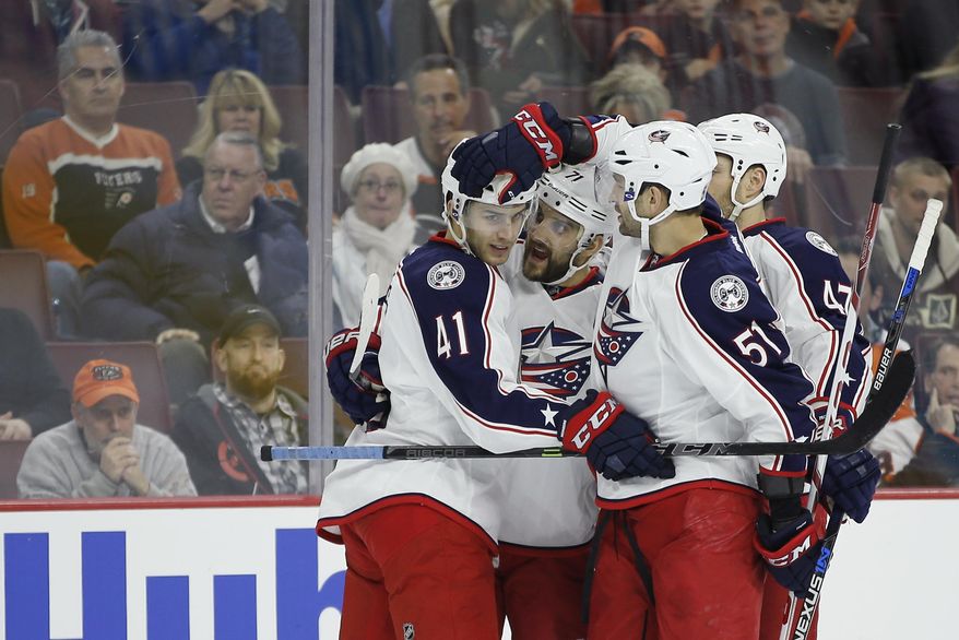 Columbus Blue Jackets&#39; Alexander Wennberg (41), Nick Foligno (71), Fedor Tyutin (51) and Dalton Prout (47) celebrate after a goal by Folingo during the first period of an NHL hockey game against the Philadelphia Flyers, Saturday, Dec. 5, 2015, in Philadelphia. (AP Photo/Matt Slocum)